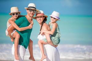 Happy family with kids on the beach together photo
