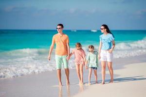 Young family with two kids on beach vacation photo