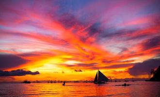 Sailing boat to the sunset photo