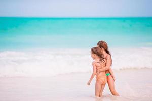 Kids have a lot of fun at tropical beach playing together photo