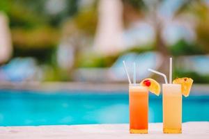 Two tasty cocktails on tropical white beach photo