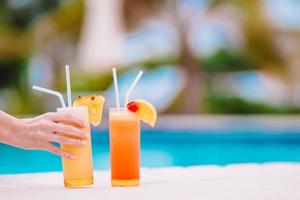 Two tasty cocktails on tropical white beach photo