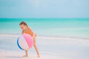 Young beautiful girl having fun on tropical seashore. photo