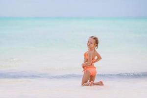 Portrait of adorable little girl at beach on her summer vacation photo