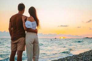 Young couple on white beach during summer vacation. photo