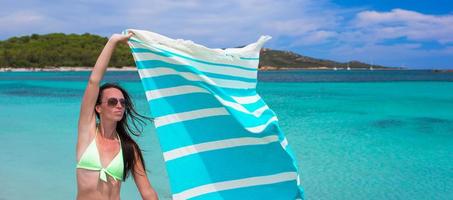 Happy woman have fun with beach towel and very happy photo