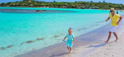 Young father and little daughter during beach vacation photo