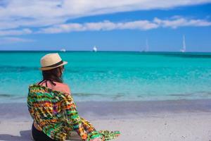 Young girl on seashore during summer vacation photo