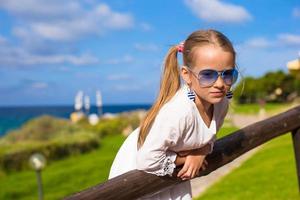 Adorable little girl outdoors during summer vacation photo