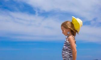 Adorable little girl have fun at tropical beach photo