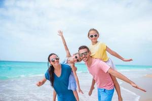 Happy beautiful family on a tropical beach vacation photo