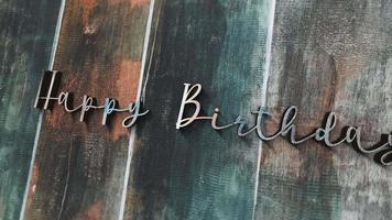 3D animation of Happy Birthday chrome text on wood video