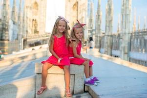 Adorable little girls on the rooftop of Duomo, Milan, Italy photo