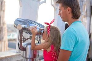 Adorable little girl with father on the rooftop of Duomo, Milan, Italy photo