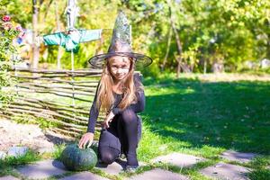 Happy little girl in halloween costume with jack pumpkin.Trick or treat photo