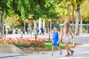 Adorable happy little girls outdoors in European city photo