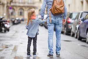 Father and his little daughter outdoors in European city photo