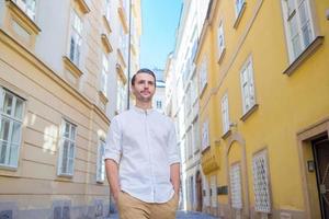 Young man background the old european city take selfie photo