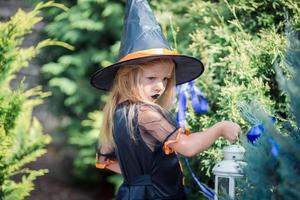 Happy girl in halloween costume with jack pumpkin.Trick or treat photo