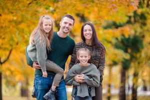 Portrait of happy family of four in autumn photo