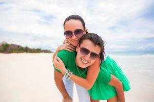 Happy young couple on exotic beach looking at camera photo