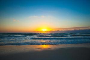 Amazing colorful sunset on exotic beach photo