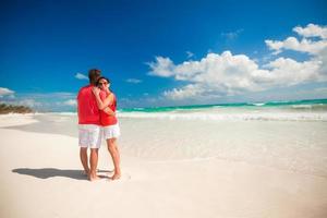 Young couple enjoying each other on a tropical beach photo