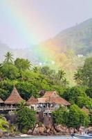 Rainbow over tropical island and luxurious hotel photo