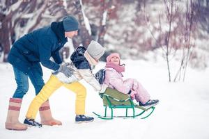 Family of dad and kids vacation on Christmas eve outdoors photo