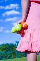 Closeup colorful Easter eggs in the hands of little pretty girl photo