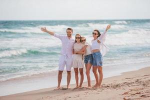 Happy family on the beach during summer vacation photo