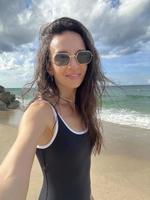 Young beautiful woman taking selfie on the beach photo