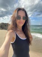 hermosa mujer joven tomando selfie en la playa foto