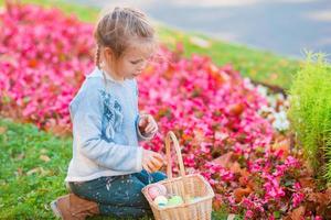 Little kid with easter eggs in busket on Easter outdoor photo