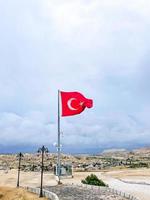 Turkish flag waving in blue sky in Cappadocia photo