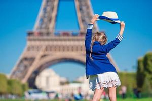 Adorable little girl in Paris background the Eiffel tower during summer vacation photo