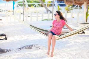 Young woman enjoying a sunny day in the hammock photo