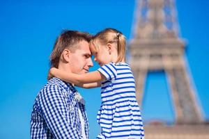 French summer holidays, travel and people concept - happy family in Paris background Eiffel Tower photo