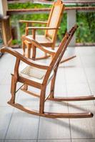 Wooden rocking chair on the terrace of an exotic hotel photo