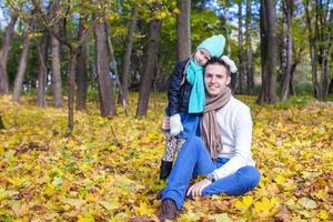 Cute little girl with happy daddy enjoy their autumn vacation on a sunny day photo