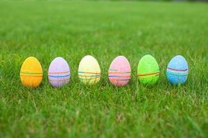 Colored colorful easter eggs in the grass photo