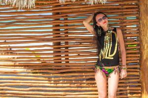 Young adorable woman in swimsuit and hat on the beach photo