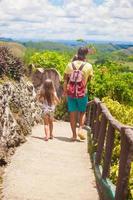 Dad with his daughter walking in tropical park at the Chocolate Hills photo