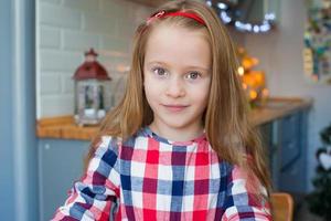 Little adorable girl baking Christmas cookies at home photo