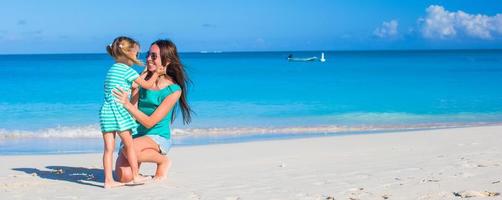 Young mom and little girl during summer vacation photo