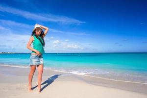 Young happy woman on beach during her summer vacation photo