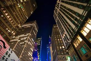 vista de los rascacielos de nueva york hacia arriba en la noche foto