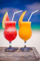 Close up fresh watermelon and mango cocktails on the background of stunning turquoise sea photo