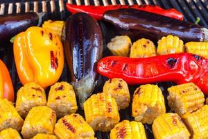 Close-up of Vegetarian barbecue and cobs corn on the grill outdoors photo