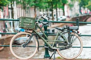 Bikes on the bridge in Amsterdam, Netherlands. Beautiful view of canals in autumn photo